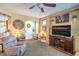 Inviting living room with cozy furniture, a ceiling fan, and lots of natural light at 3709 Corte Bella Hills Ave, North Las Vegas, NV 89081