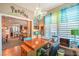 Home office with wood desk, chandelier lighting, and open access to kitchen area at 3709 Corte Bella Hills Ave, North Las Vegas, NV 89081