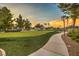Putting green with adjacent walking path, surrounded by mature trees at 3709 Corte Bella Hills Ave, North Las Vegas, NV 89081