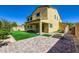 Back exterior view with a covered patio, brick walkway, and manicured lawn at 397 Pearl Fountains Ct, Las Vegas, NV 89148