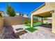 The backyard features a covered patio and artificial turf, ideal for relaxation and entertainment at 397 Pearl Fountains Ct, Las Vegas, NV 89148