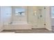 Contemporary bathroom featuring a soaking tub and a large shower with glass doors and bright natural light at 397 Pearl Fountains Ct, Las Vegas, NV 89148