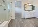 Bright bathroom featuring a walk-in shower with glass doors, a modern vanity, and wood-look tile flooring at 397 Pearl Fountains Ct, Las Vegas, NV 89148