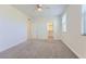 Spacious bedroom with carpet, ceiling fan and light, and open closet space, ideal for storage and organizing at 397 Pearl Fountains Ct, Las Vegas, NV 89148