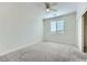 A bright bedroom features neutral carpet, a ceiling fan, and a window with horizontal blinds at 397 Pearl Fountains Ct, Las Vegas, NV 89148