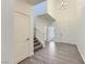 Bright entryway boasts wood-look tile floors, stairs, and high ceilings with chandelier lighting at 397 Pearl Fountains Ct, Las Vegas, NV 89148