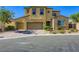 Charming two-story home with a well-manicured lawn, three car garage, and stylish stone accents at 397 Pearl Fountains Ct, Las Vegas, NV 89148