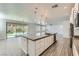 Beautiful kitchen with a large island and bar seating, stainless steel appliances, and sliding door to backyard at 397 Pearl Fountains Ct, Las Vegas, NV 89148