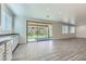 Bright living room with sliding glass doors to the backyard and stylish flooring at 397 Pearl Fountains Ct, Las Vegas, NV 89148