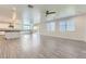 Open-concept living room and kitchen features wood-look tile floors and sliding door to backyard at 397 Pearl Fountains Ct, Las Vegas, NV 89148