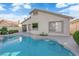 Backyard view featuring a swimming pool, spa, desert landscaping, and rear home elevation at 412 Carlton Kay Pl, Las Vegas, NV 89144