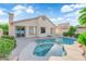 Private backyard showcasing a refreshing pool, spa, and well-maintained landscaping at 412 Carlton Kay Pl, Las Vegas, NV 89144