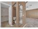 Bathroom featuring tiled floors, a toilet, and a glimpse into the bedroom at 412 Carlton Kay Pl, Las Vegas, NV 89144