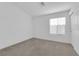 Bright bedroom with neutral carpet, white walls, and a window with blinds for natural light at 412 Carlton Kay Pl, Las Vegas, NV 89144
