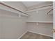Walk-in closet featuring multiple shelves and hanging rods for maximum storage at 412 Carlton Kay Pl, Las Vegas, NV 89144