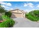 Inviting single-story residence with a two-car garage and lush, green shrubbery at 412 Carlton Kay Pl, Las Vegas, NV 89144