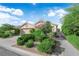 Attractive single-story house featuring a two-car garage, mature trees, and lush landscaping at 412 Carlton Kay Pl, Las Vegas, NV 89144
