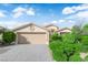 Beautiful single-story home featuring a two-car garage and mature landscaping at 412 Carlton Kay Pl, Las Vegas, NV 89144