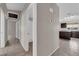 Hallway leading to bathroom and kitchen, showcasing tiled floor and modern interior design at 412 Carlton Kay Pl, Las Vegas, NV 89144