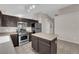 Well-lit kitchen features stainless steel appliances and a kitchen island at 412 Carlton Kay Pl, Las Vegas, NV 89144