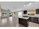 Modern kitchen with dark cabinets, an island, and an adjoining living area at 412 Carlton Kay Pl, Las Vegas, NV 89144