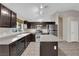 Bright kitchen includes an island, stainless steel appliances, and tile flooring at 412 Carlton Kay Pl, Las Vegas, NV 89144