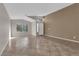 Bright living room featuring tile floors, high ceilings, and large windows at 412 Carlton Kay Pl, Las Vegas, NV 89144