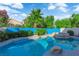Inviting backyard pool and spa surrounded by mature landscaping and lush greenery at 412 Carlton Kay Pl, Las Vegas, NV 89144