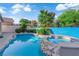 Inviting backyard pool and spa surrounded by mature landscaping and lush greenery at 412 Carlton Kay Pl, Las Vegas, NV 89144