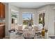 Bright eat-in kitchen nook with wrap-around windows and a wood dining table at 445 Colorful Rain Ave, North Las Vegas, NV 89031