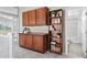 Hallway featuring built-in wooden cabinets and a bookcase, leading to a full bathroom at 445 Colorful Rain Ave, North Las Vegas, NV 89031