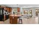 Eat-in kitchen featuring wood cabinetry, an island with barstool seating, and stainless steel appliances at 445 Colorful Rain Ave, North Las Vegas, NV 89031