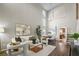 Bright and airy living room with high ceilings, modern furnishings, and dark wood flooring at 445 Colorful Rain Ave, North Las Vegas, NV 89031