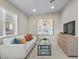 Cozy sitting room with comfortable seating, modern decor, and a large window for natural light at 445 Colorful Rain Ave, North Las Vegas, NV 89031
