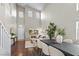 Bright open-concept living area with tall ceilings and a view of the dining area at 445 Colorful Rain Ave, North Las Vegas, NV 89031