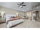 Spacious main bedroom featuring a ceiling fan, sitting area, and ensuite bathroom access at 445 Colorful Rain Ave, North Las Vegas, NV 89031
