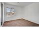 Cozy bedroom featuring neutral carpet, white walls and a bright window view to the outside at 4829 Hot Springs Ave, Las Vegas, NV 89110