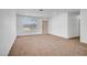 Bright living room with neutral walls, plush carpet, and ample natural light at 4829 Hot Springs Ave, Las Vegas, NV 89110