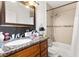 Bathroom featuring granite vanity, framed mirror, and shower/tub combo with tile surround at 5052 S Rainbow Blvd # 201, Las Vegas, NV 89118