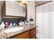 Bathroom featuring granite vanity, framed mirror, and shower/tub combo with tile surround at 5052 S Rainbow Blvd # 201, Las Vegas, NV 89118