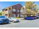 Exterior view of the building featuring stucco facade, car parking, and landscaping at 5052 S Rainbow Blvd # 201, Las Vegas, NV 89118