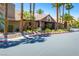 Exterior of the clubhouse featuring desert landscaping and palm trees in a well maintained environment at 5052 S Rainbow Blvd # 201, Las Vegas, NV 89118