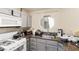 Efficient kitchen layout with neutral cabinets, granite counters, and essential appliances for cooking convenience at 5052 S Rainbow Blvd # 201, Las Vegas, NV 89118