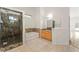 Bathroom with marble walled shower, soaking tub, vanity, and neutral flooring at 517 Chance Cove Dr, Henderson, NV 89052