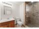 Bathroom with a glass enclosed shower, vanity, toilet, and updated fixtures and tiled walls at 517 Chance Cove Dr, Henderson, NV 89052