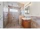 Modern bathroom featuring a glass shower enclosure with multiple shower heads and a tile backsplash at 517 Chance Cove Dr, Henderson, NV 89052
