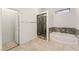 This bathroom features a walk-in shower with decorative tile and a separate soaking tub at 517 Chance Cove Dr, Henderson, NV 89052
