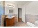 Bathroom with tiled walls, tiled floors, wood vanity, and access to bedroom at 517 Chance Cove Dr, Henderson, NV 89052