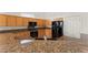 Large kitchen has granite counters, tile floors, light wood cabinets, and black appliances at 517 Chance Cove Dr, Henderson, NV 89052