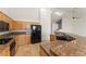 Close-up of kitchen with black appliances, light wood cabinets, and granite countertops at 517 Chance Cove Dr, Henderson, NV 89052
